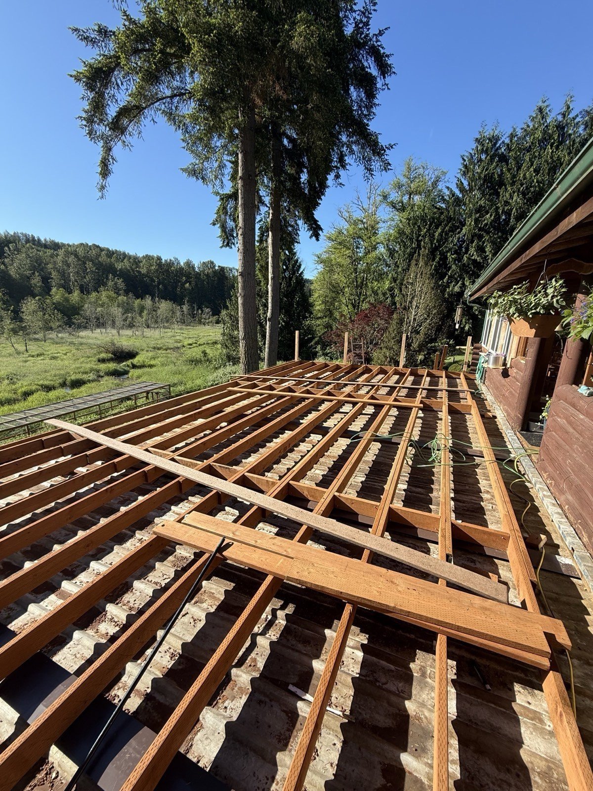 Deck framing under construction with joists and support beams